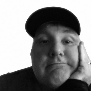 Andy Wells — black-and-white self-portrait, visibly unimpressed